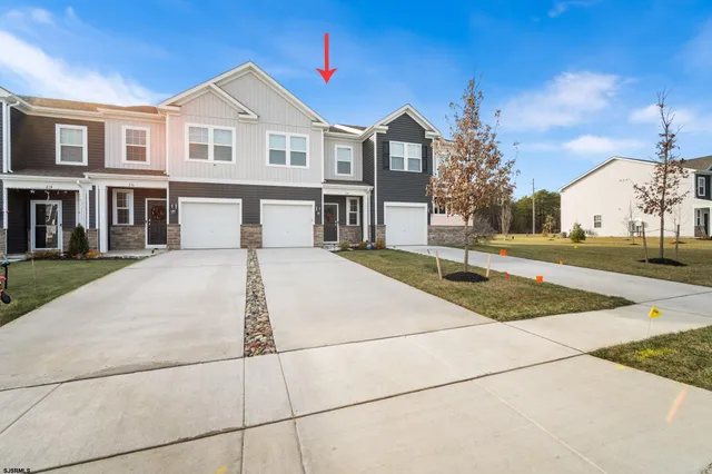 a view of a white house with a yard