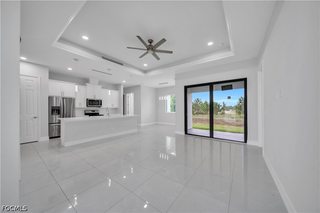 3509 38th Street Southwest Lehigh Acres, FL 33976 - Photo 10 of 47 a view of an empty room with a window and kitchen view