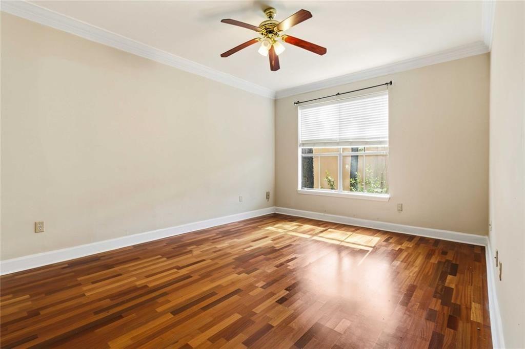 3777 Peachtree Road Northeast, Unit 533 Brookhaven, GA 30319 - Photo 14 of 30 a view of an empty room with window and wooden floor