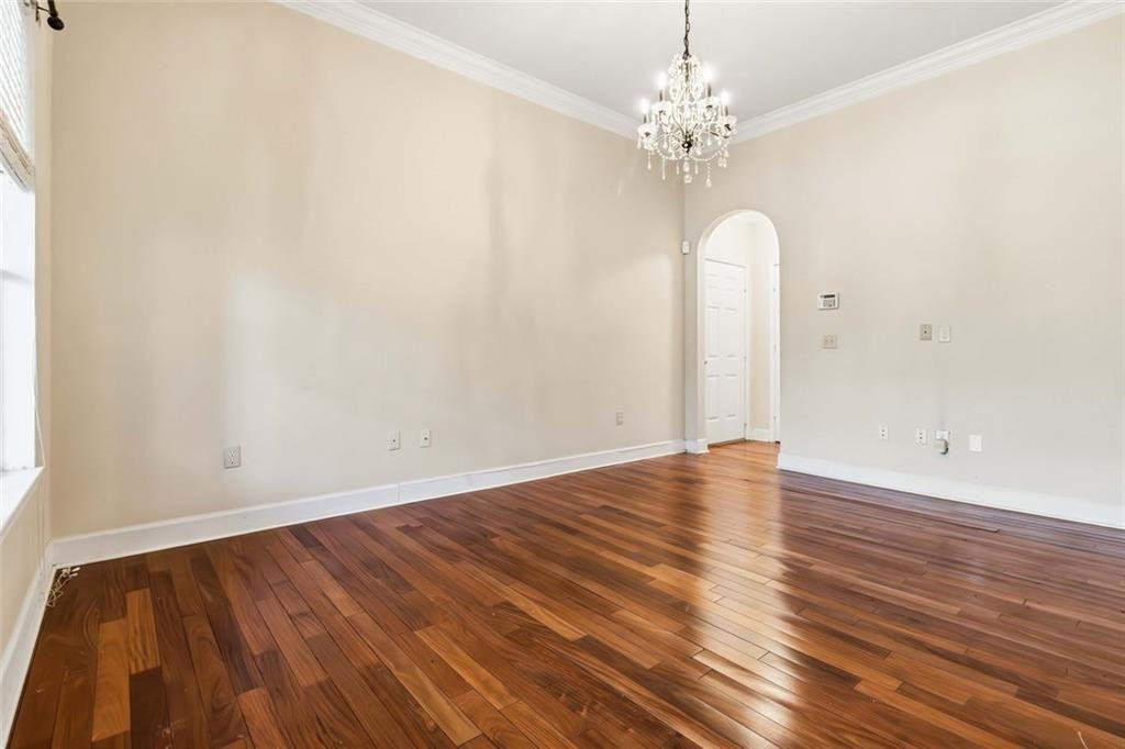 3777 Peachtree Road Northeast, Unit 533 Brookhaven, GA 30319 - Photo 16 of 30 a view of a room with wooden floor and chandelier