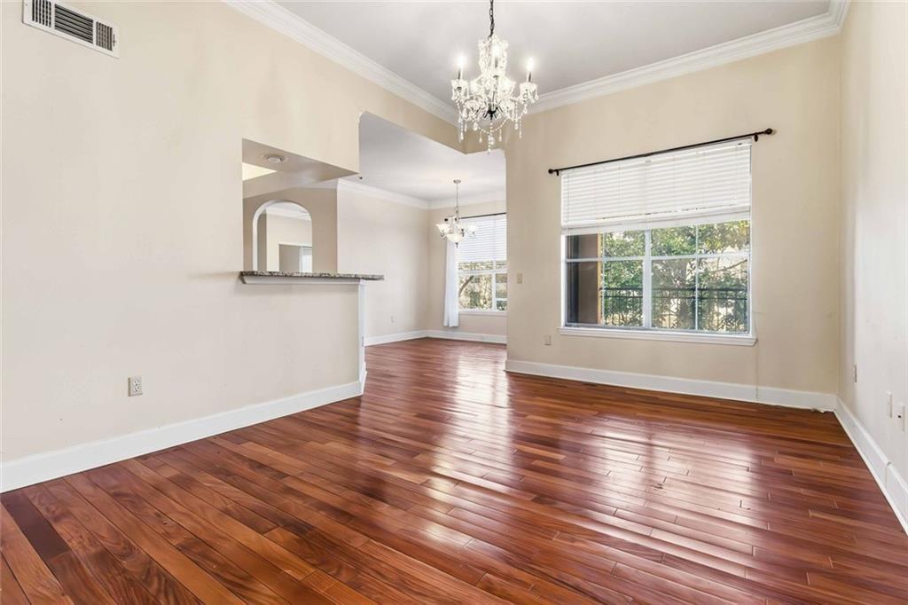 3777 Peachtree Road Northeast, Unit 533 Brookhaven, GA 30319 - Photo 17 of 30 a view of an empty room with wooden floor and a window