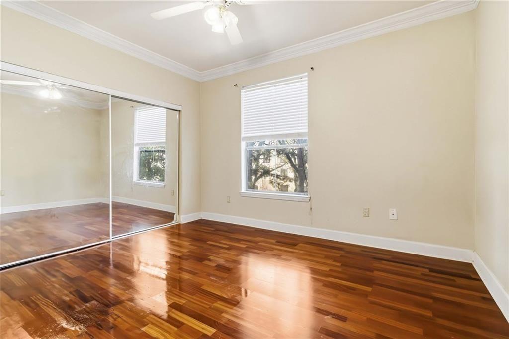 3777 Peachtree Road Northeast, Unit 533 Brookhaven, GA 30319 - Photo 18 of 30 a view of an empty room with window and wooden floor