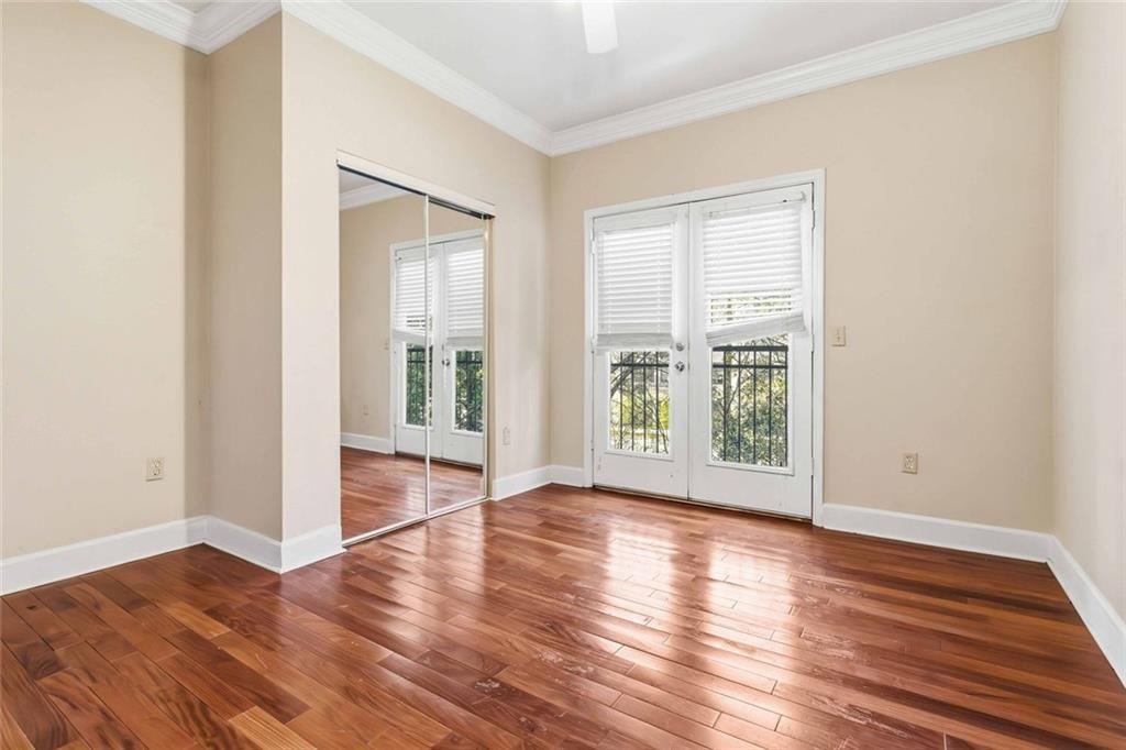 3777 Peachtree Road Northeast, Unit 533 Brookhaven, GA 30319 - Photo 20 of 30 a view of an empty room with wooden floor and a window