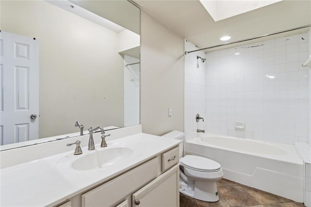 3777 Peachtree Road Northeast, Unit 533 Brookhaven, GA 30319 - Photo 21 of 30 a bathroom with a sink toilet vanity and shower