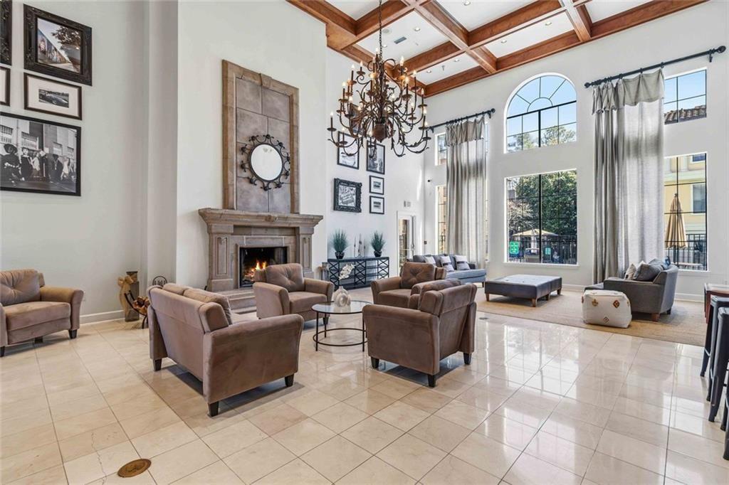 3777 Peachtree Road Northeast, Unit 533 Brookhaven, GA 30319 - Photo 30 of 30 a living room with furniture a fireplace a large window and a chandelier