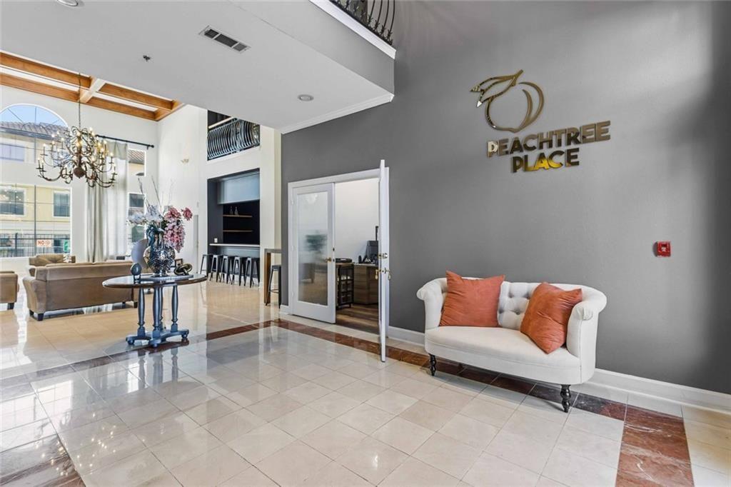 3777 Peachtree Road Northeast, Unit 533 Brookhaven, GA 30319 - Photo 3 of 30 a living room with furniture and a flat screen tv