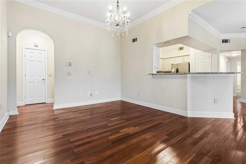 3777 Peachtree Road Northeast, Unit 533 Brookhaven, GA 30319 - Photo 3 of 30 a view of a room with wooden floor and window