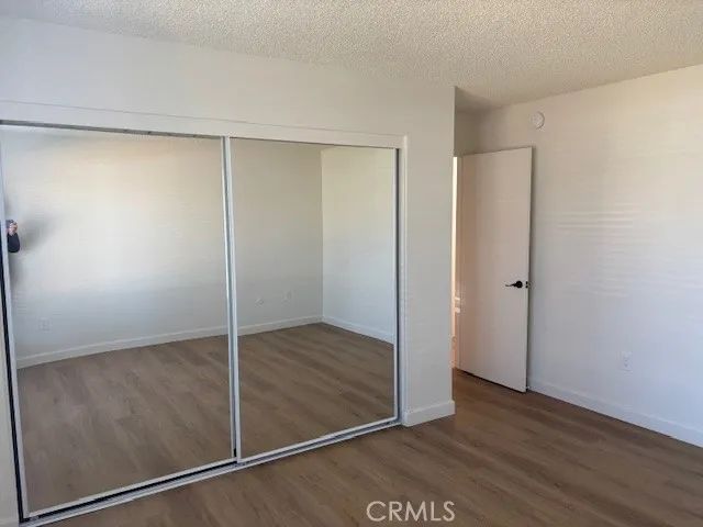 an empty room with wooden floor