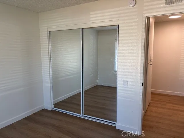 an empty room with wooden floor