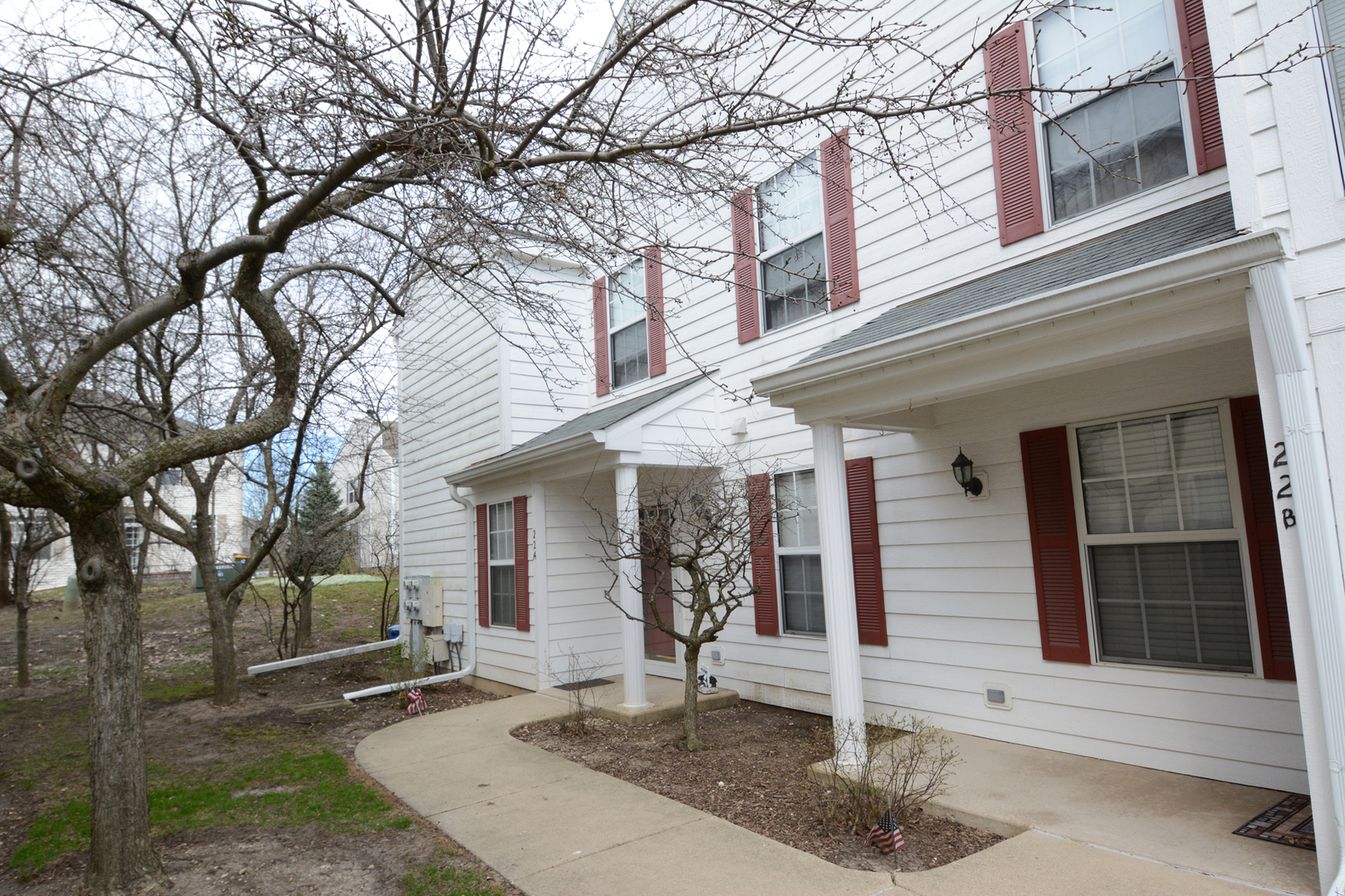 22 Tyler Court, Unit A Streamwood, IL 60107 - Photo 2 of 27 a front view of a house with garden