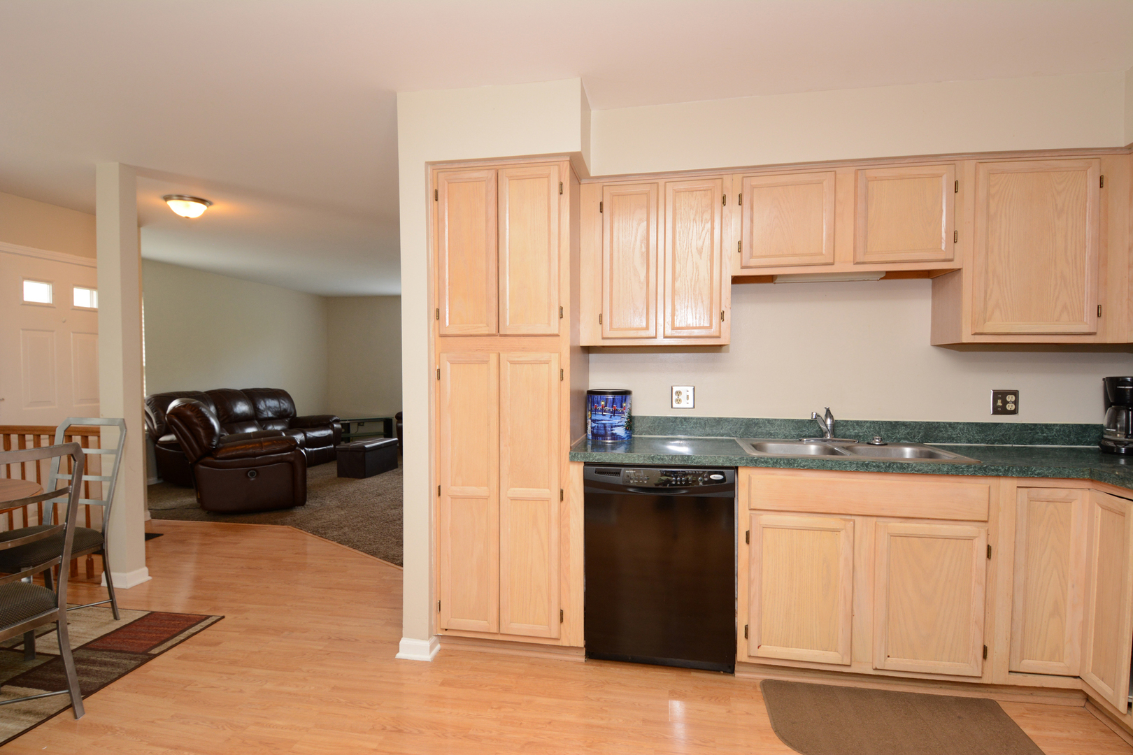 22 Tyler Court, Unit A Streamwood, IL 60107 - Photo 11 of 27 a kitchen with granite countertop a refrigerator sink and cabinets