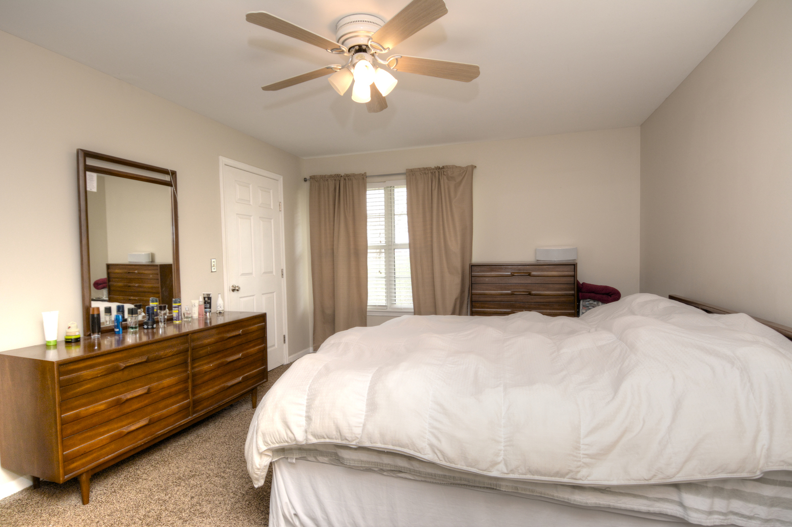 22 Tyler Court, Unit A Streamwood, IL 60107 - Photo 14 of 27 a bedroom with a bed and a chandelier