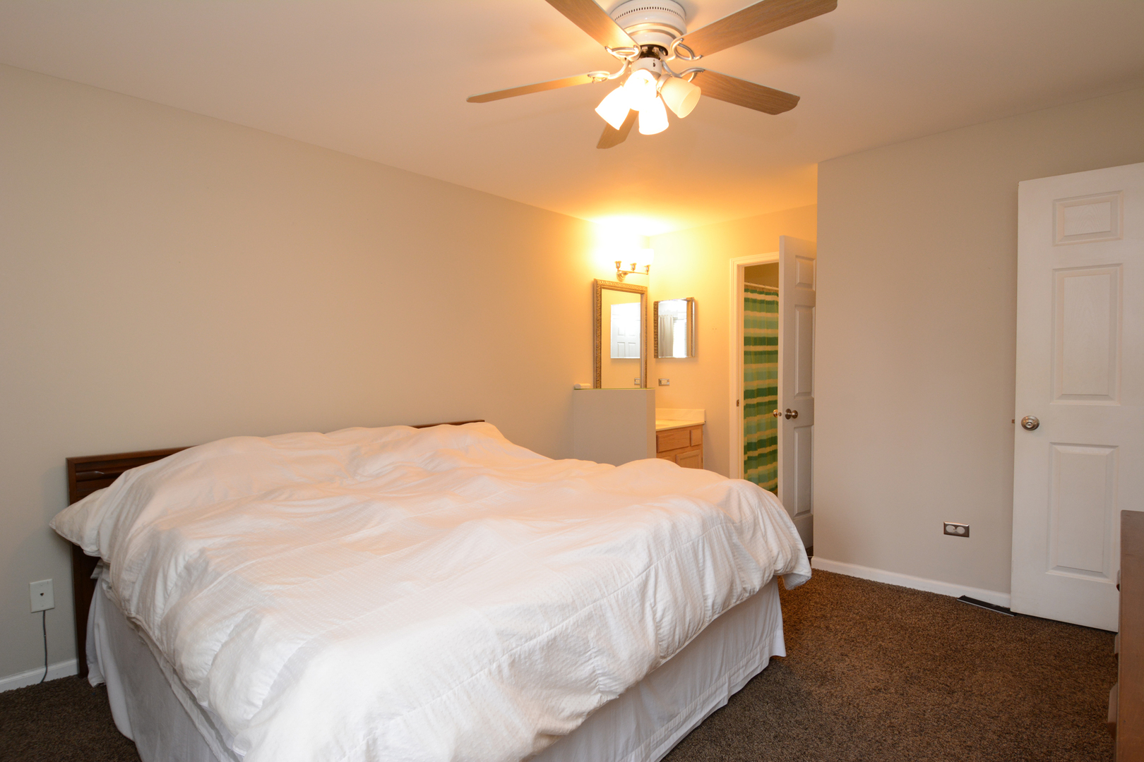 22 Tyler Court, Unit A Streamwood, IL 60107 - Photo 15 of 27 a large bed sitting in a bedroom next to a window and a chandelier