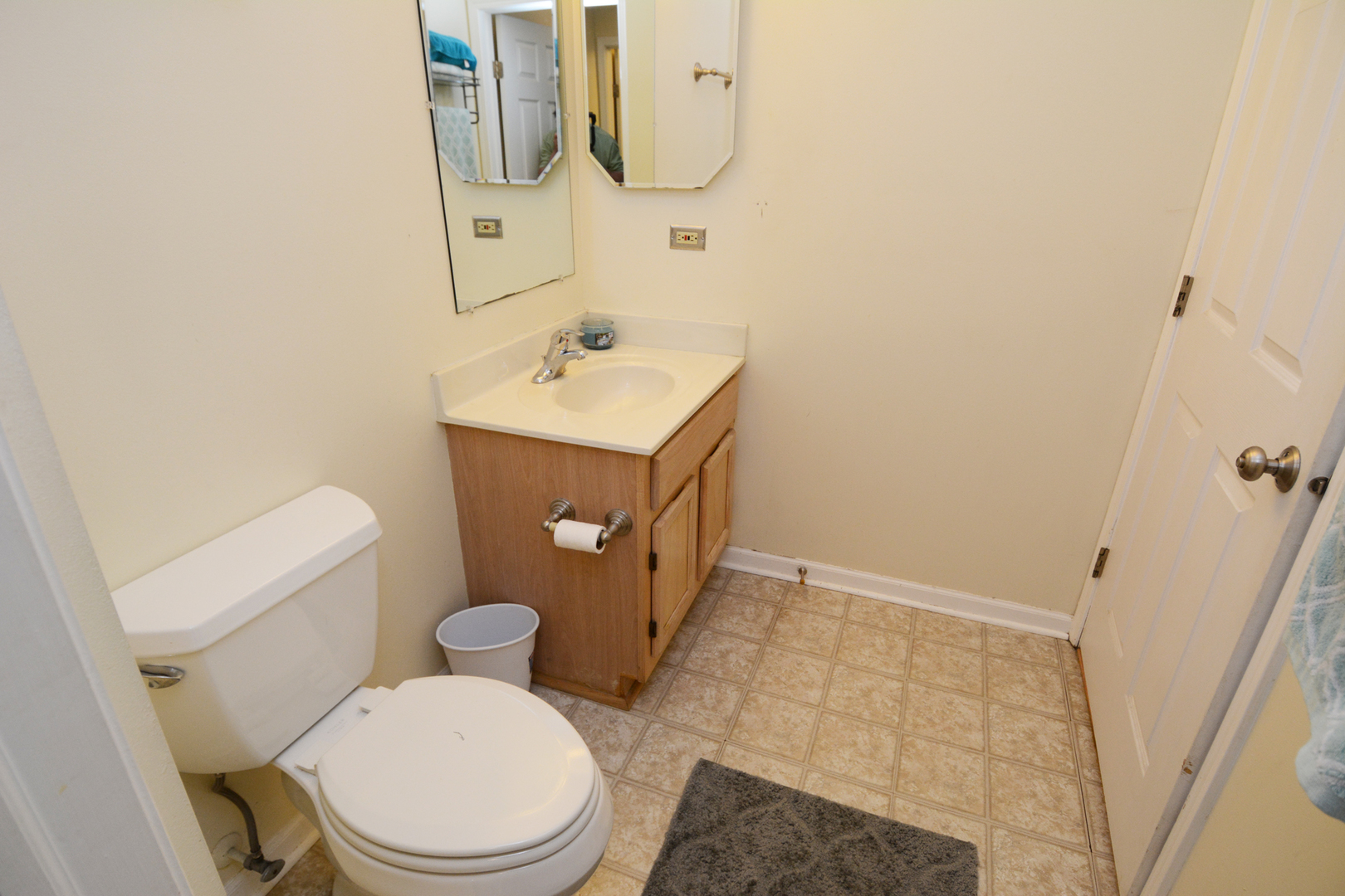 22 Tyler Court, Unit A Streamwood, IL 60107 - Photo 17 of 27 a bathroom with a sink a toilet and mirror