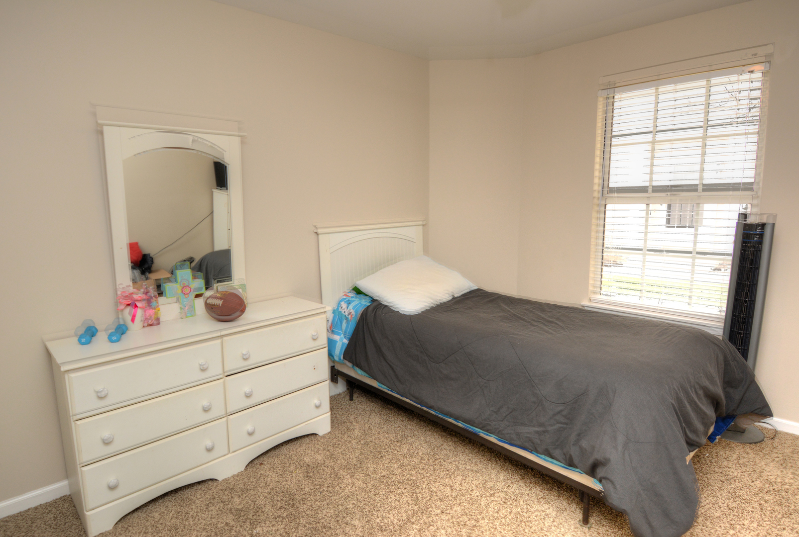 22 Tyler Court, Unit A Streamwood, IL 60107 - Photo 18 of 27 a bedroom with a bed and a dresser