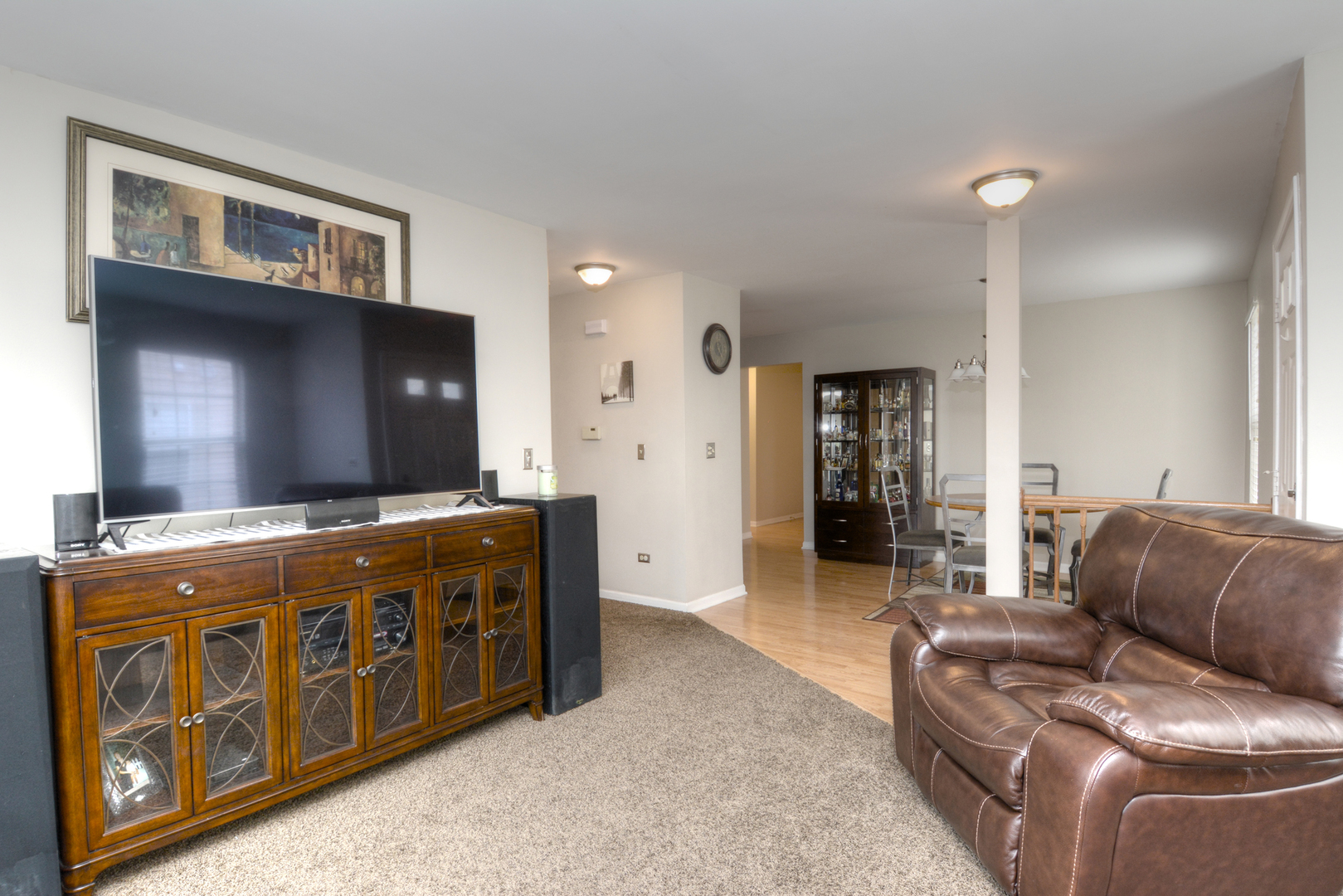 22 Tyler Court, Unit A Streamwood, IL 60107 - Photo 5 of 27 a living room with furniture and a flat screen tv