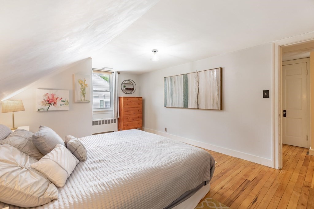 51 Ridge Street Arlington, MA 02474 - Photo 11 of 28 a bedroom with a large bed and a window