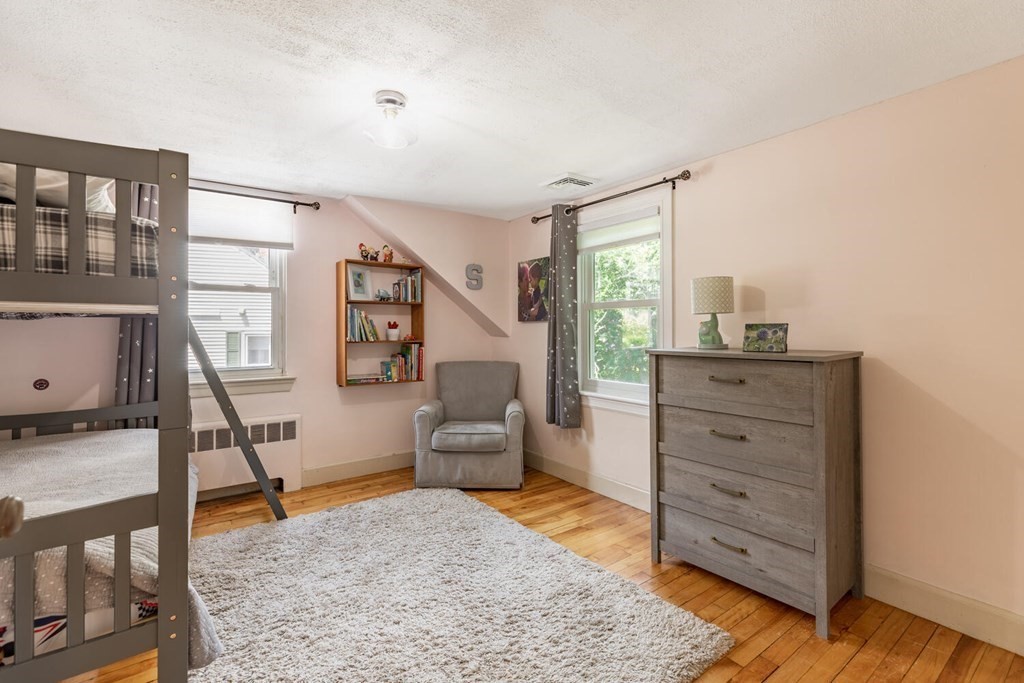 51 Ridge Street Arlington, MA 02474 - Photo 12 of 28 a living room with furniture and a dresser