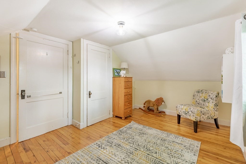 51 Ridge Street Arlington, MA 02474 - Photo 16 of 28 a bedroom with a bed and a wooden floor