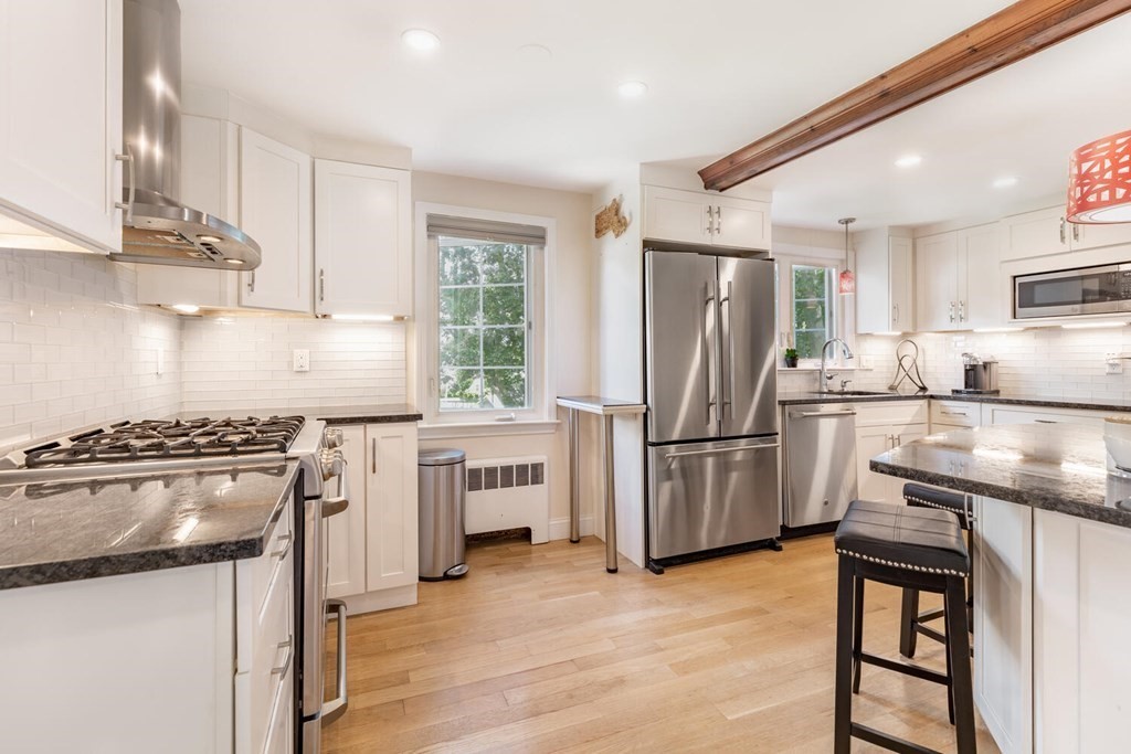 51 Ridge Street Arlington, MA 02474 - Photo 2 of 28 a kitchen with a stove a refrigerator and a sink