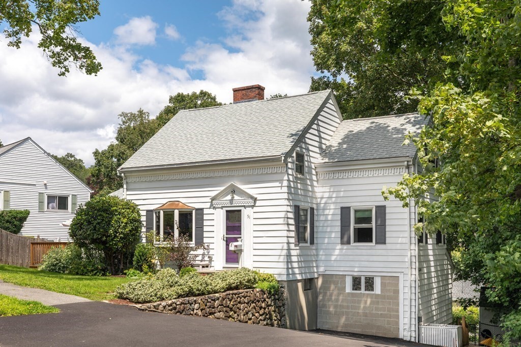 51 Ridge Street Arlington, MA 02474 - Photo 21 of 28 a view of a white house with large windows and a small yard