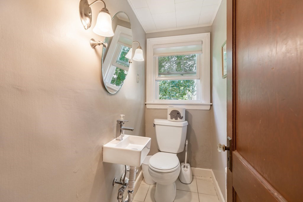 51 Ridge Street Arlington, MA 02474 - Photo 7 of 28 a white toilet sitting next to a bathroom sink