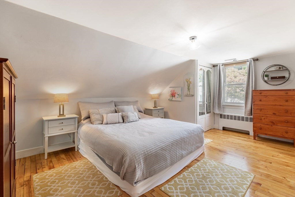 51 Ridge Street Arlington, MA 02474 - Photo 9 of 28 a bedroom with a bed and a table in it