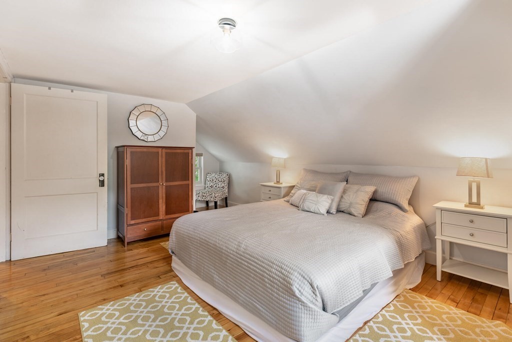 51 Ridge Street Arlington, MA 02474 - Photo 10 of 28 a bedroom with a bed and a lamp on dresser