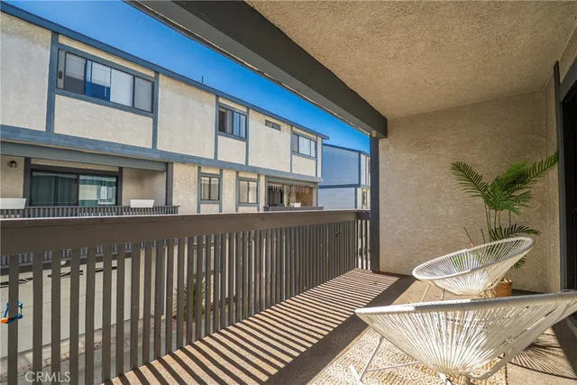 a balcony view with a seating space