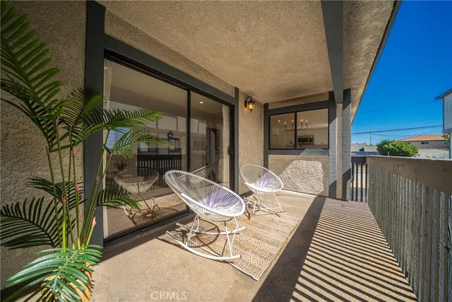 a patio with yard glass top table and chairs