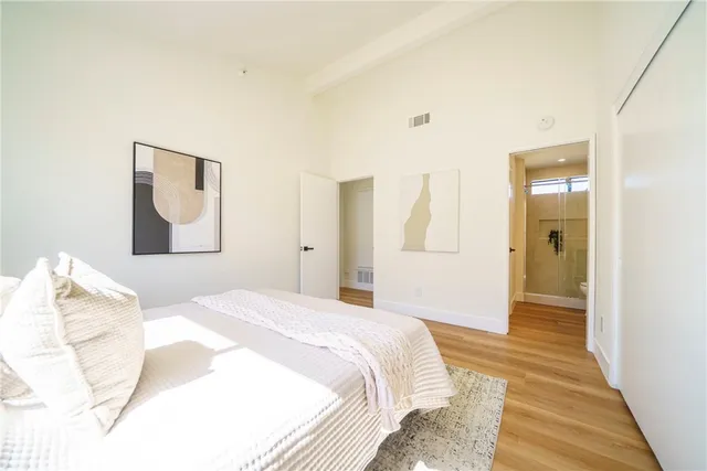 a bedroom with a bed and a painting