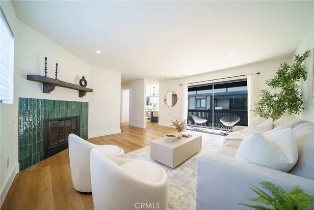 a living room with furniture a fireplace and a potted plant