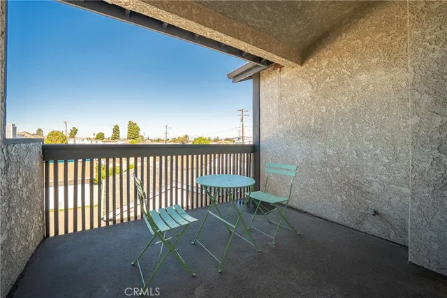 a view of a chair and table in the balcony