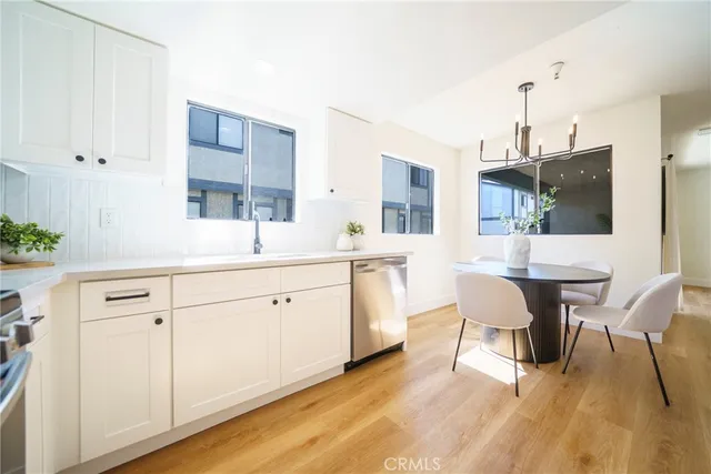 a kitchen with a sink cabinets and wooden floor