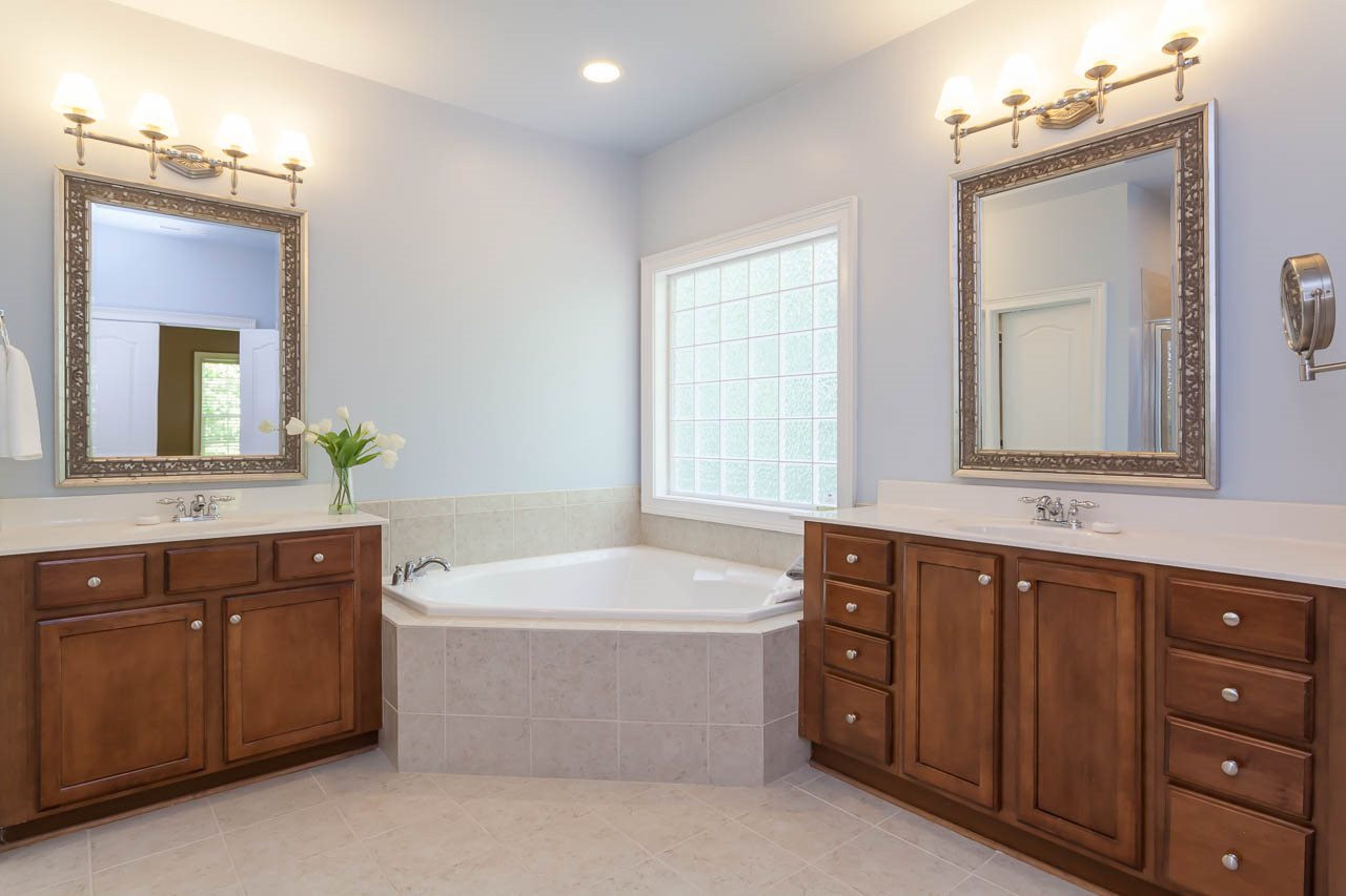 8000 Jessamine Way Raleigh, NC 27612 - Photo 19 of 25 The master bath is absolutely beautiful and offers double vanities with custom mirrors and lovely light fixtures. Master Bath