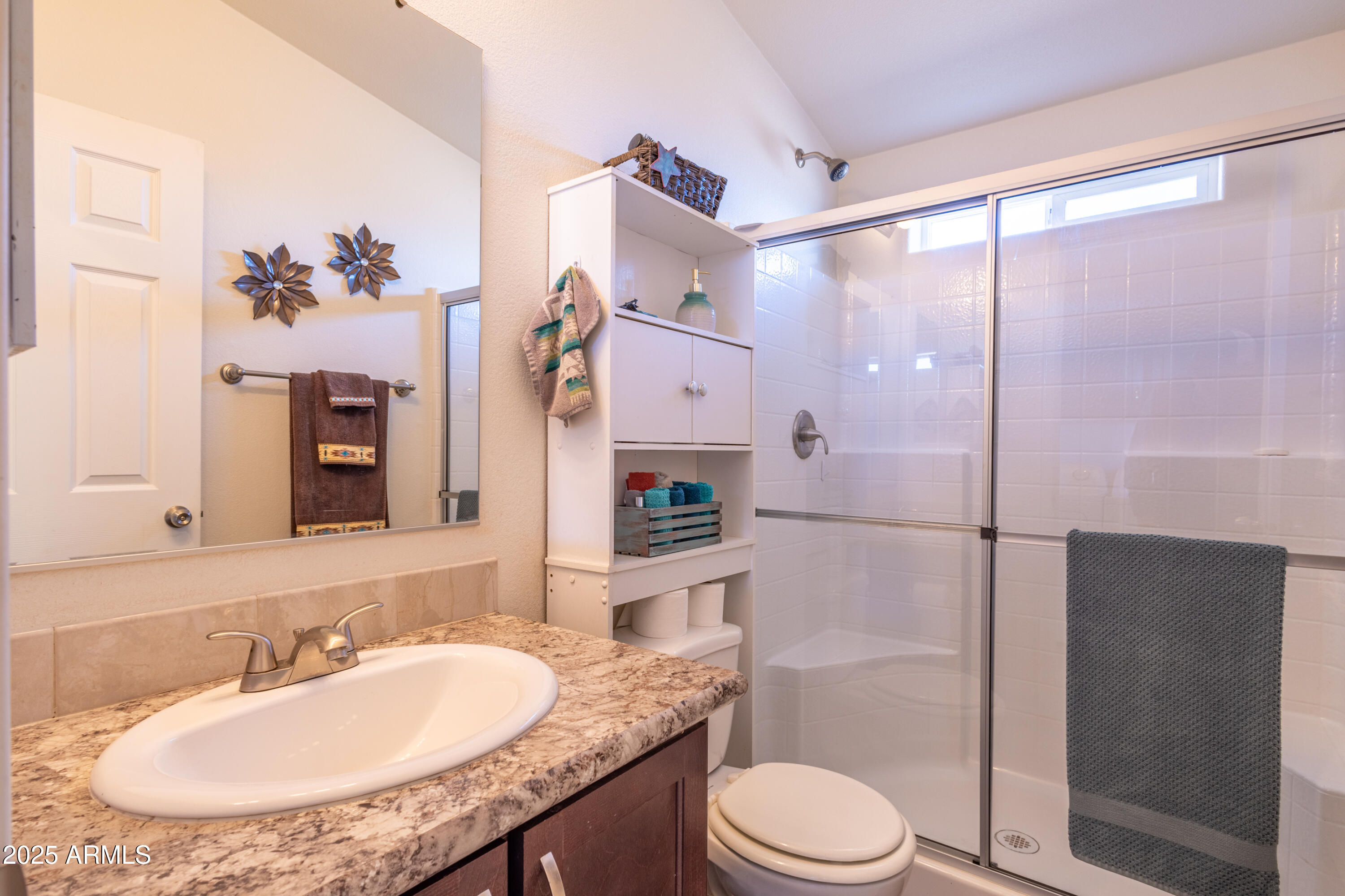 45409 West Luray Road Wickenburg, AZ 85390 - Photo 12 of 26 a bathroom with a granite countertop sink toilet a large mirror and shower