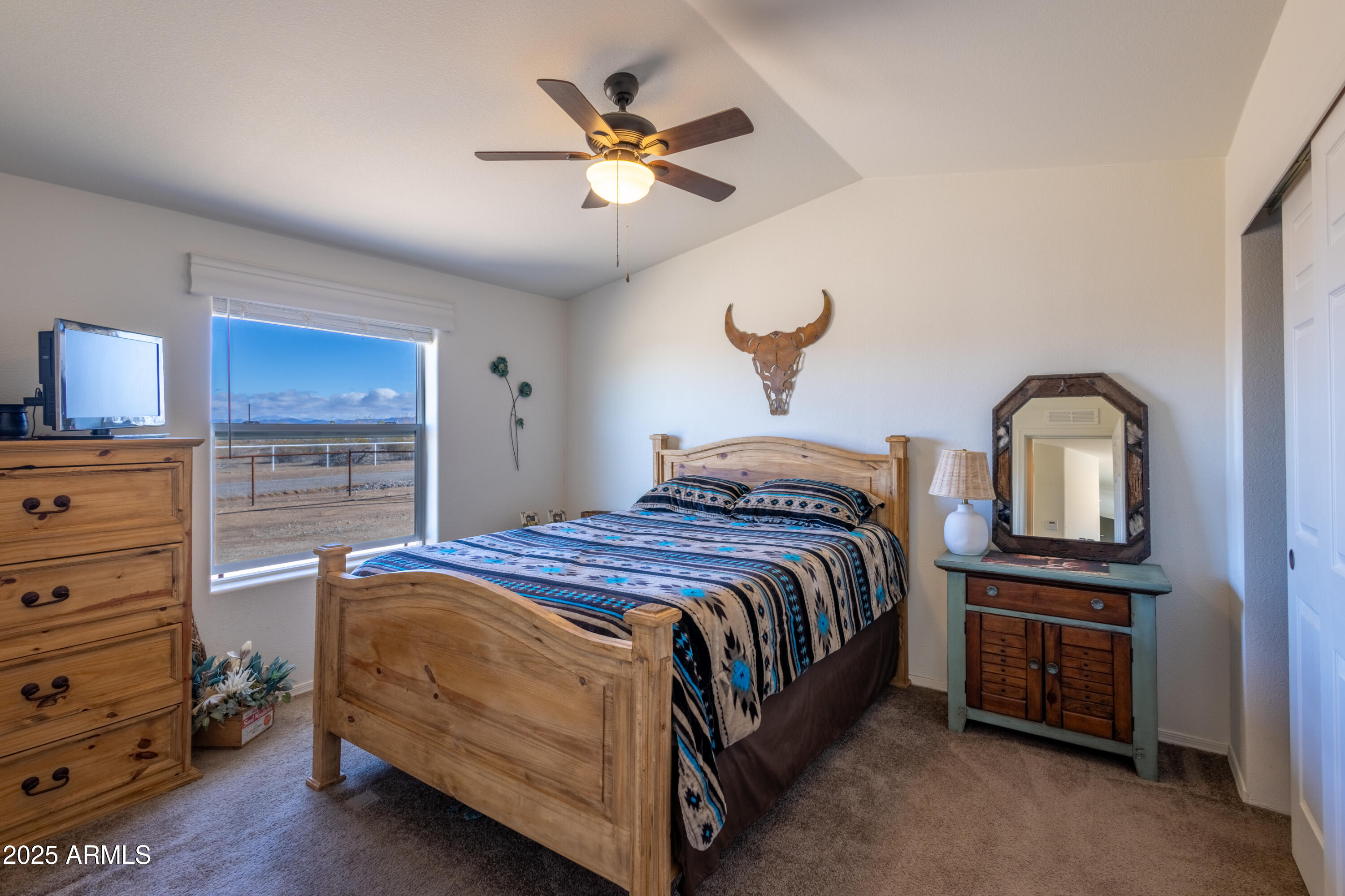 45409 West Luray Road Wickenburg, AZ 85390 - Photo 13 of 26 a bedroom with a bed and a chandelier