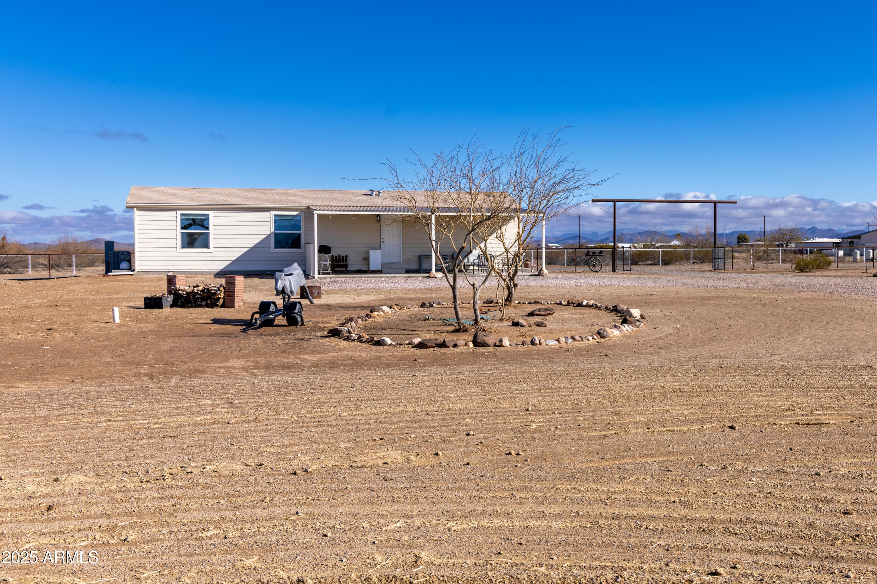 45409 West Luray Road Wickenburg, AZ 85390 - Photo 4 of 26 a view of a house with a yard