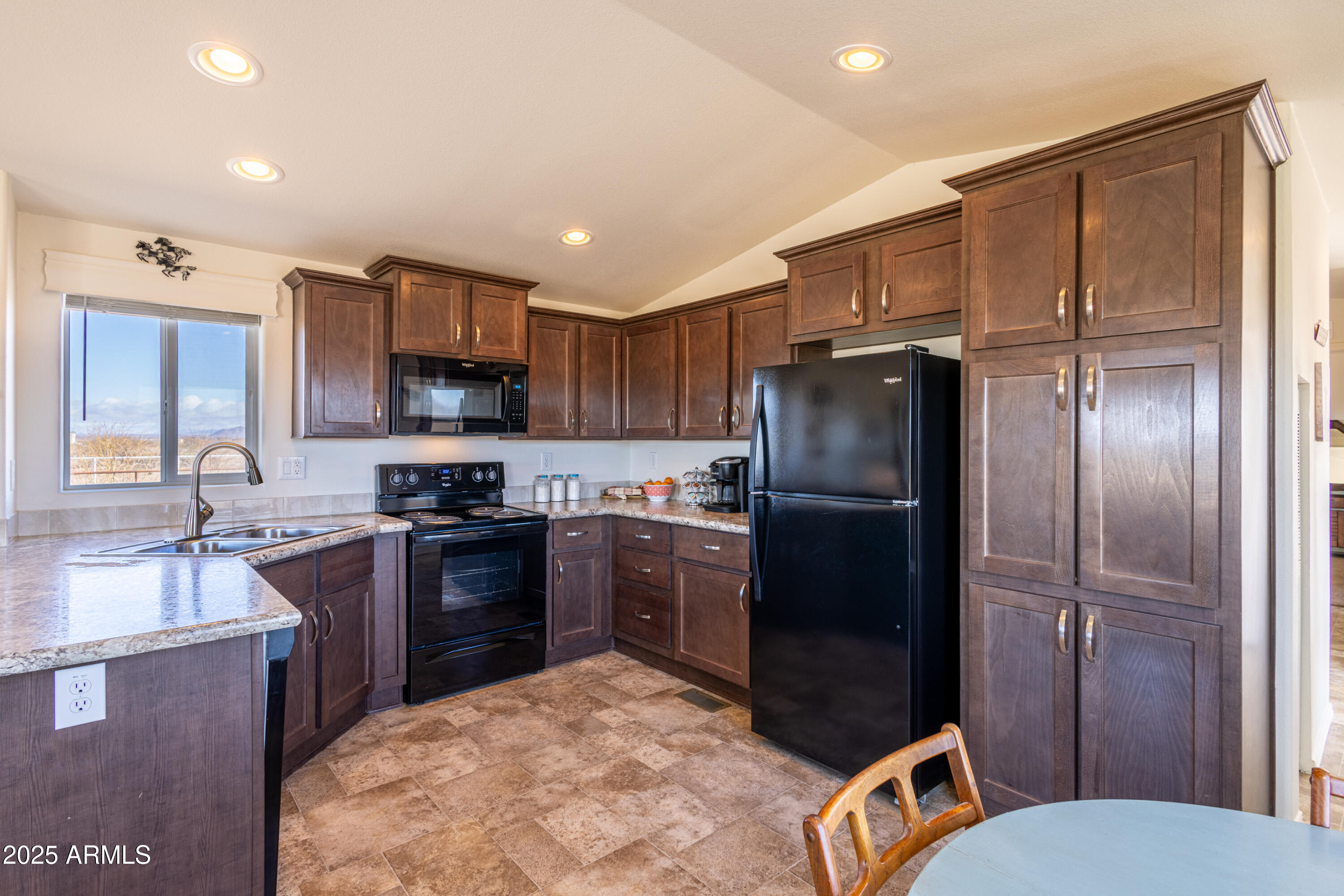 45409 West Luray Road Wickenburg, AZ 85390 - Photo 6 of 26 a kitchen with granite countertop stainless steel appliances a refrigerator stove microwave and sink