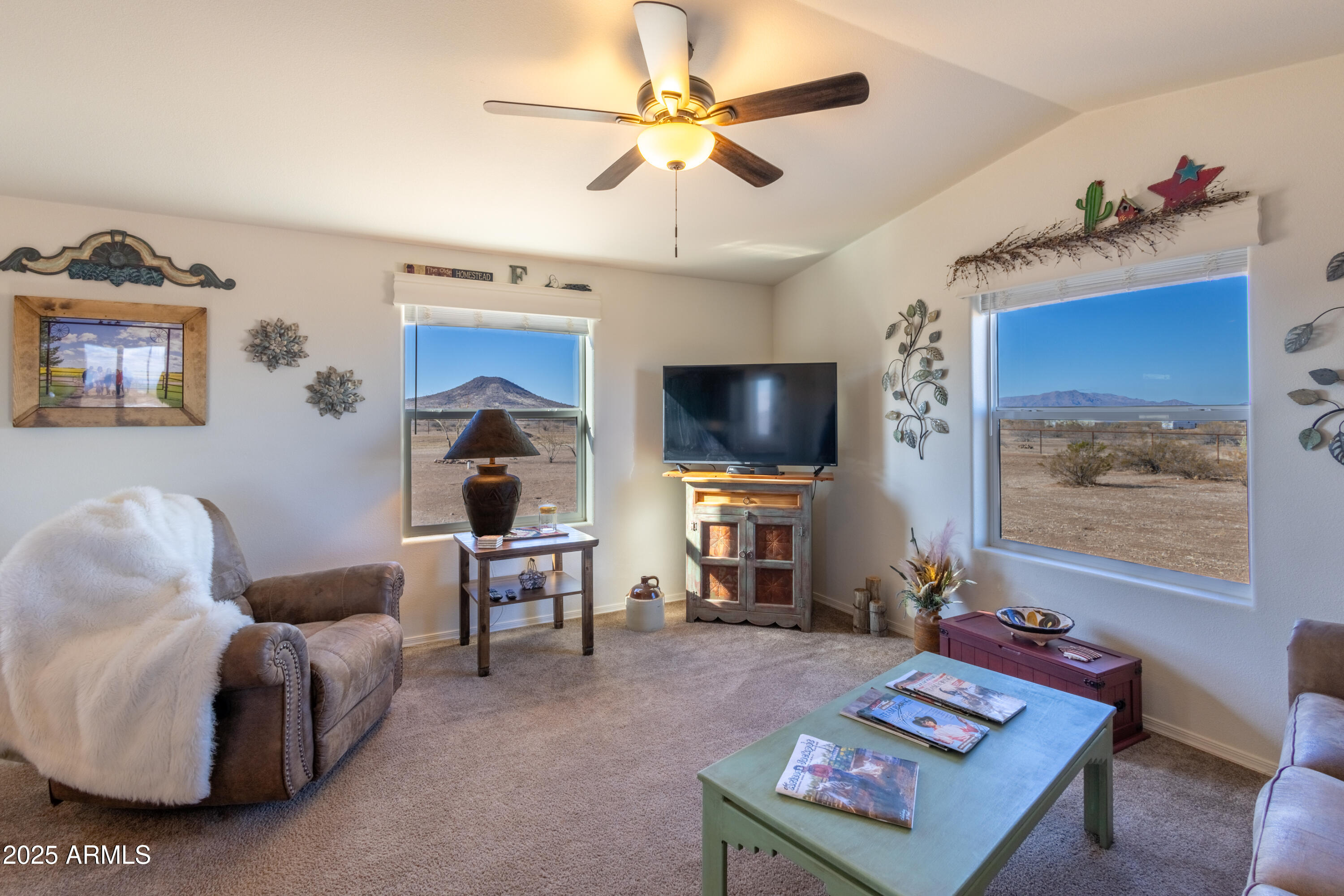 45409 West Luray Road Wickenburg, AZ 85390 - Photo 9 of 26 a living room with furniture a flat screen tv and a chandelier