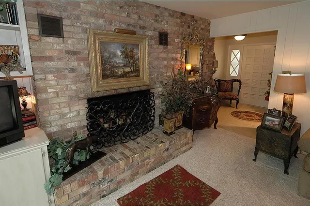 a living room with furniture hard wood floor and a window