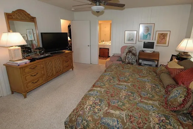 a spacious bedroom with bed and a couch