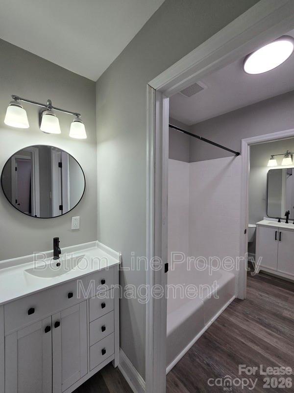 5949 Quail Hollow Road, Unit D Charlotte, NC 28210 - Photo 32 of 34 a bathroom with a double vanity sink mirror and bathtub