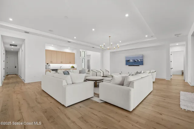 a kitchen with a dining table chairs sink and wooden floor