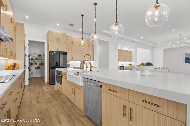 a view of a hallway with wooden floor and a bathroom