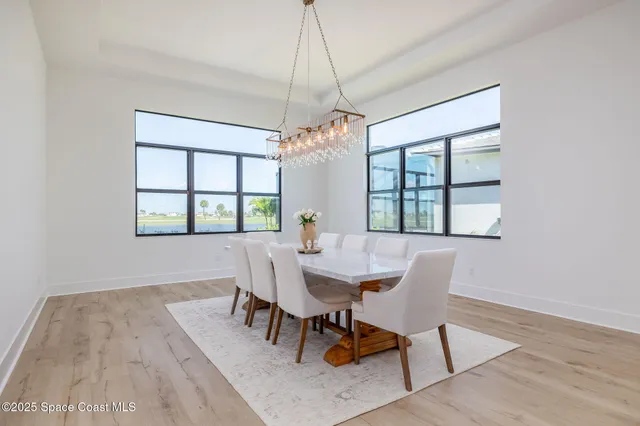 a room with gym equipment and wooden floor