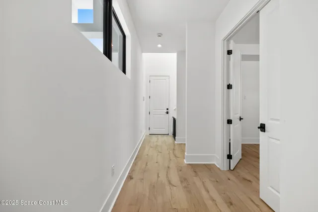 a bathroom with a toilet a sink a glass door a shower and a mirror