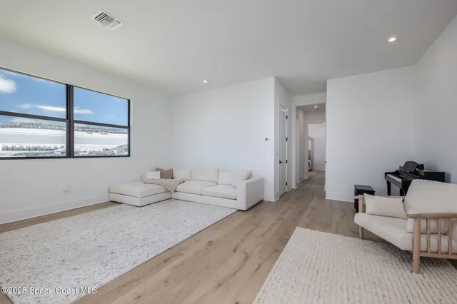 a front view of a house with a yard and potted plants
