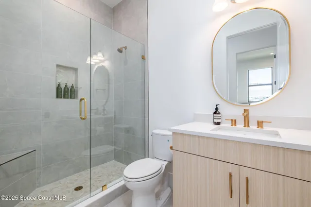 an aerial view of a house with a garden and lake view