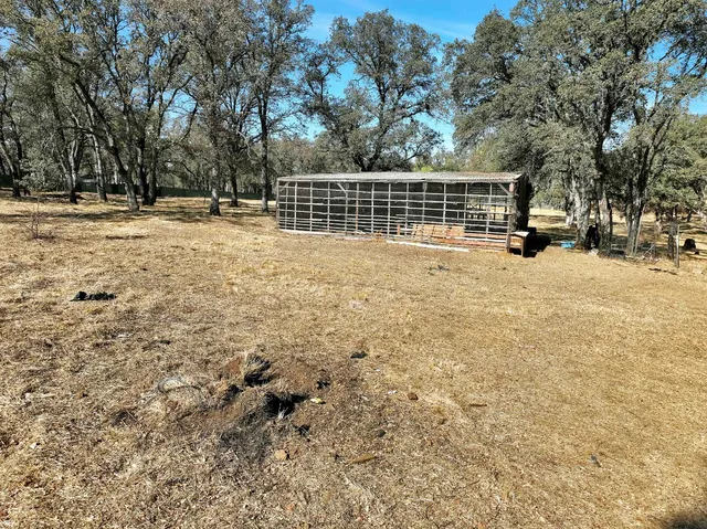 a backyard of a house with table and chairs